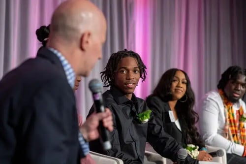 People listen to a speaker at the leadership awards