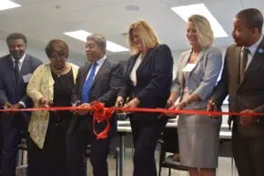 Six people at ribbon cutting ceremony